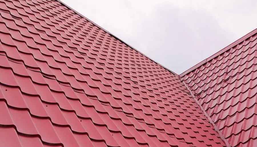 Bright red metal roofing in a V-shape pitch, showcasing a durable solution by Northland Roofing.