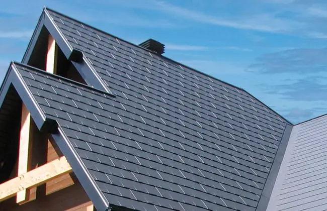 Dark grey composite roofing tiles on a steep roof, part of a recent project by Northland Roofing.