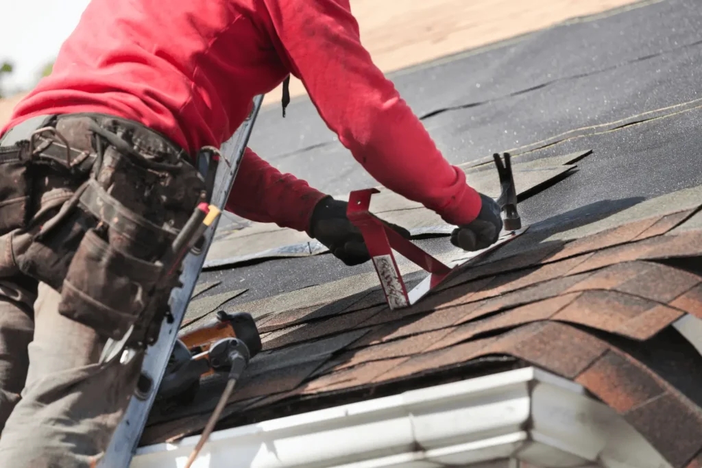 Northland Roofing professional repairing minor leaks on a shingle roof as part of routine roof repairs.