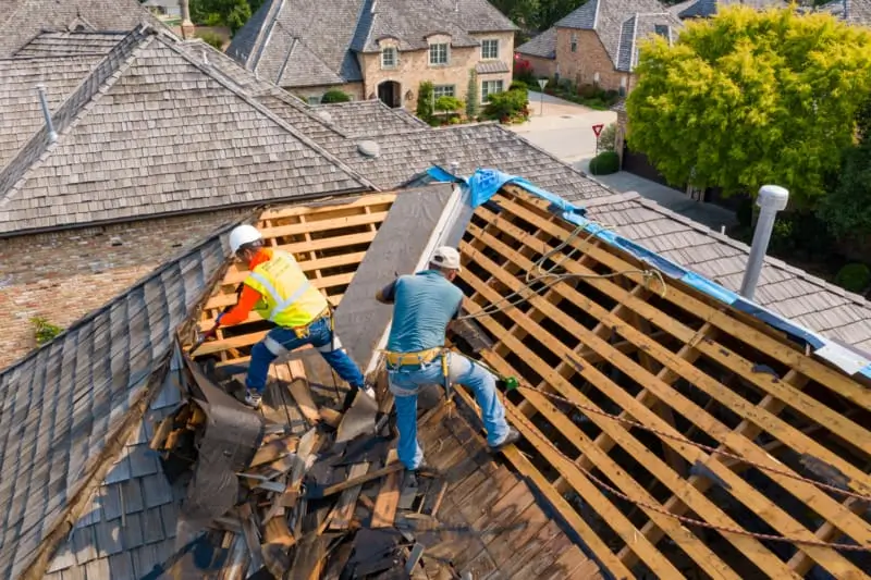 Northland Roofing professionals remove old shingles as part of a comprehensive re-roofing job.