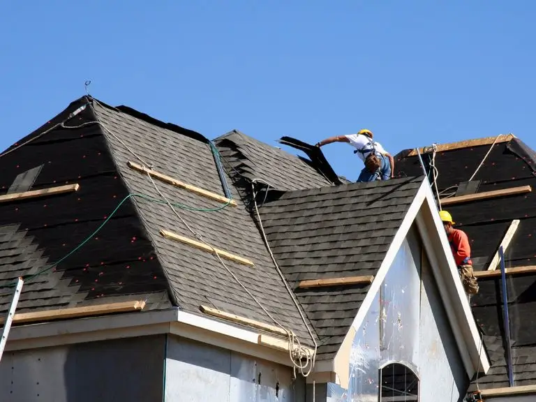 Skilled crew from Northland Roofing re-roofing a complex multi-gable roofline.