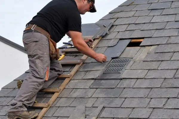 Slate tiles being fitted by a skilled tradesman during Northland Roofing roof repairs.