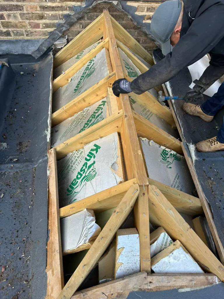 Structural timber repair in progress by Northland Roofing as part of roof repairs beneath old insulation.